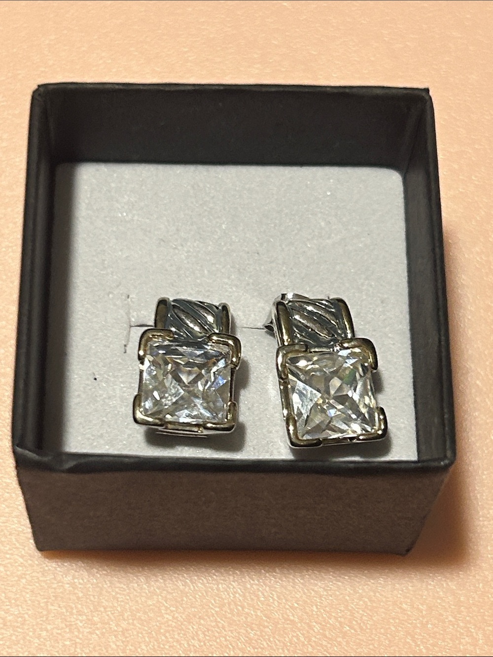 Silver tone princess cut cubic zirconia stud earrings ft. a textured twist top